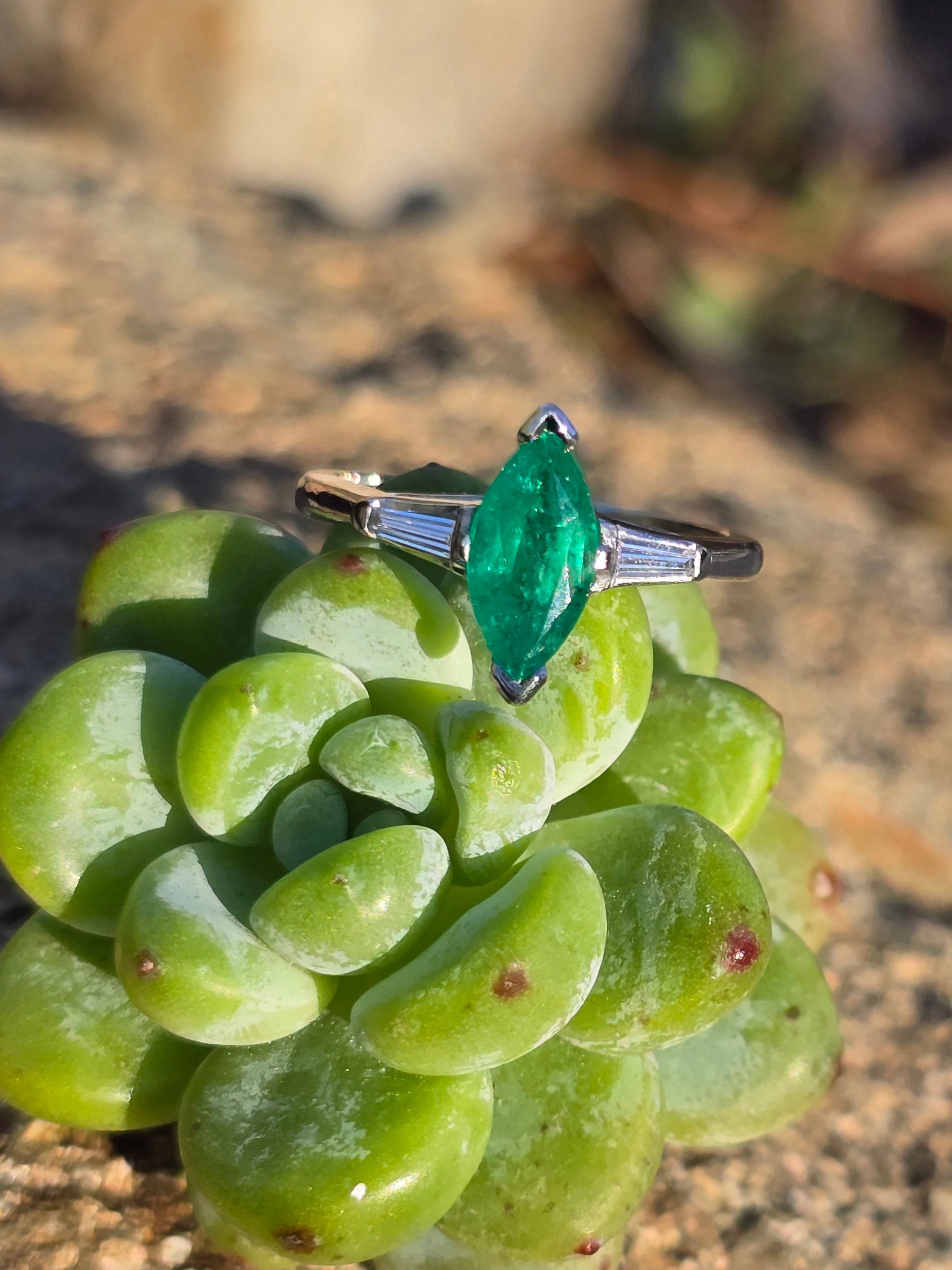 Platinum marquise emerald and baguette diamond estate ring